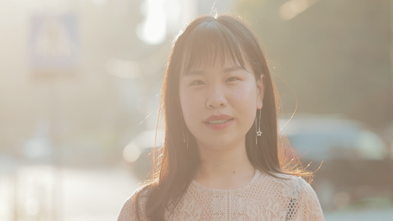 Portrait of a young woman with braces and earrings