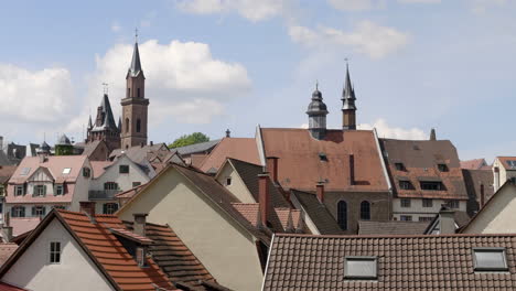 detail of rooftop and houses of weinheim city with saint lawrence church tower on sunny day