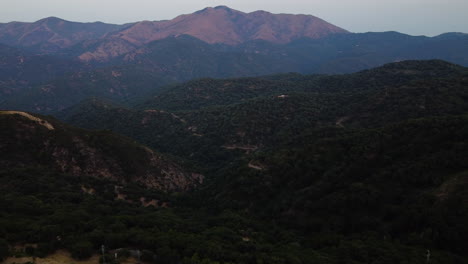 A-drone-aerial-of-a-forest-valley-in-Pico-De-Los-Reales,-Estepona,-Spain