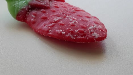 Slow-tilting-movement-of-big-strawberry-jelly-on-a-table-in-studio-environment-at-home