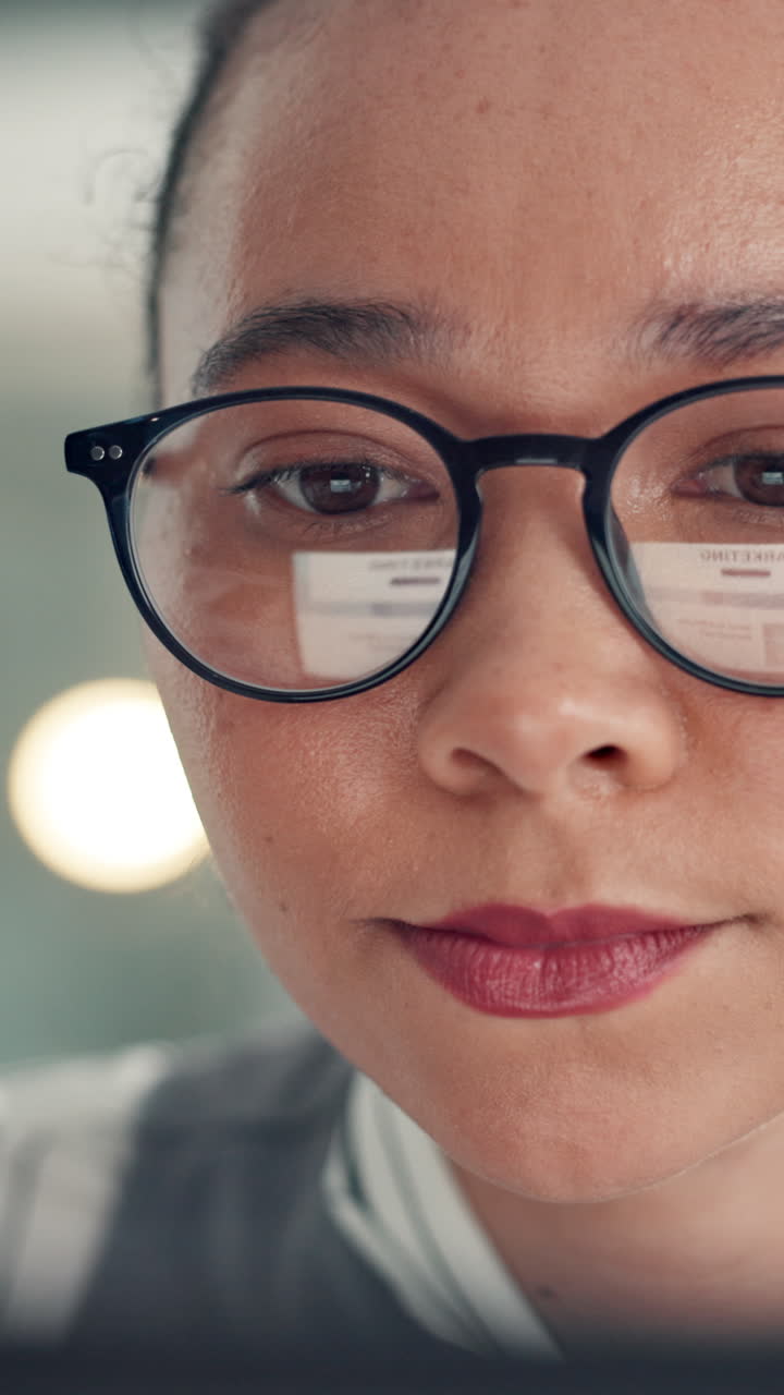 Focused Woman's Face with Digital Screen Reflection in Eyeglasses