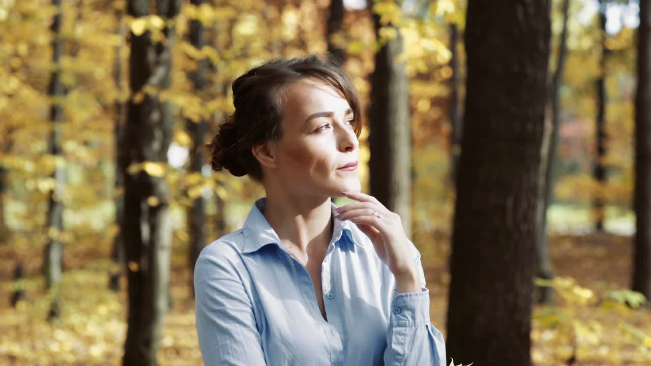 Woman in autumn park. Outdoors portrait of beautiful young woman in autumn park