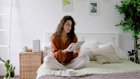 Caucasian woman sitting on the bed