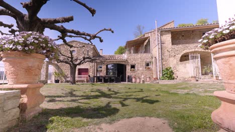 slow dolly shot revealing a beautiful stone villa in the tresques countryside