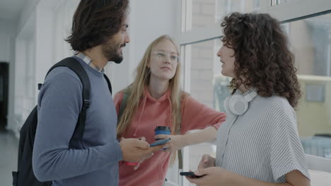 students talking in a university hallway