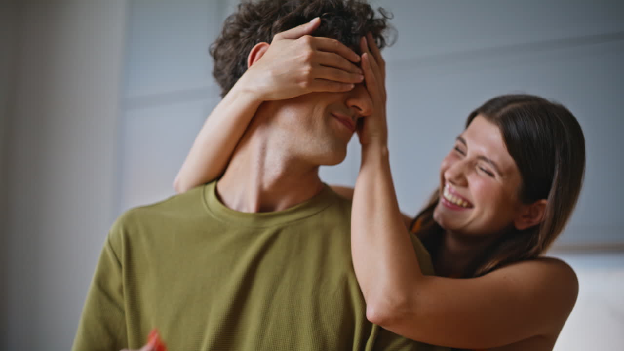 Man hands slicing vegetables home kitchen closeup. Woman closing husband eyes