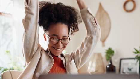 happy woman celebrating success with laptop