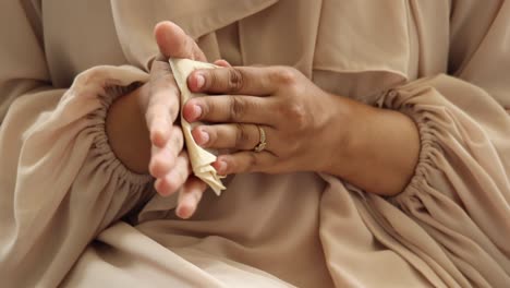 woman cleaning her hands with a tissue