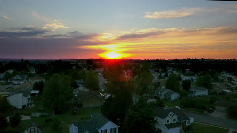 a floating drone shot over houses in the suburbs of utah at sunset