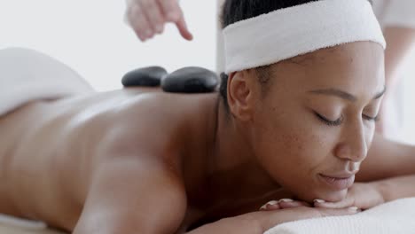 Woman-Receiving-A-Massage-With-Hot-Stone