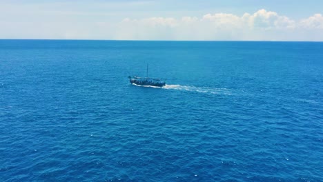 A-pirate-sail-boat-moving-in-middle-of-the-Caribbean-ocean-|-Pirate-sail-boat-sailing-in-Caribbean-sea-looking-like-dragon-boat,-aerial-view-drone-shot