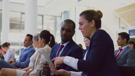 business people discussing over digital tablet in a seminar 4k