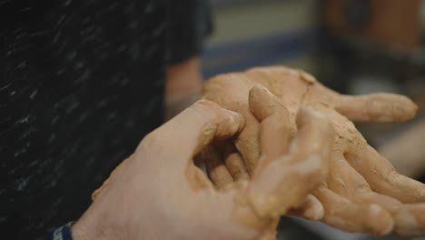 skilled worker removing splinter from hand - artisan at work