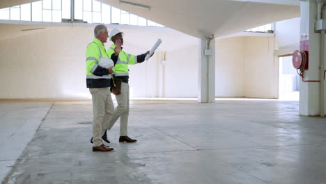 construction workers inspecting warehouse