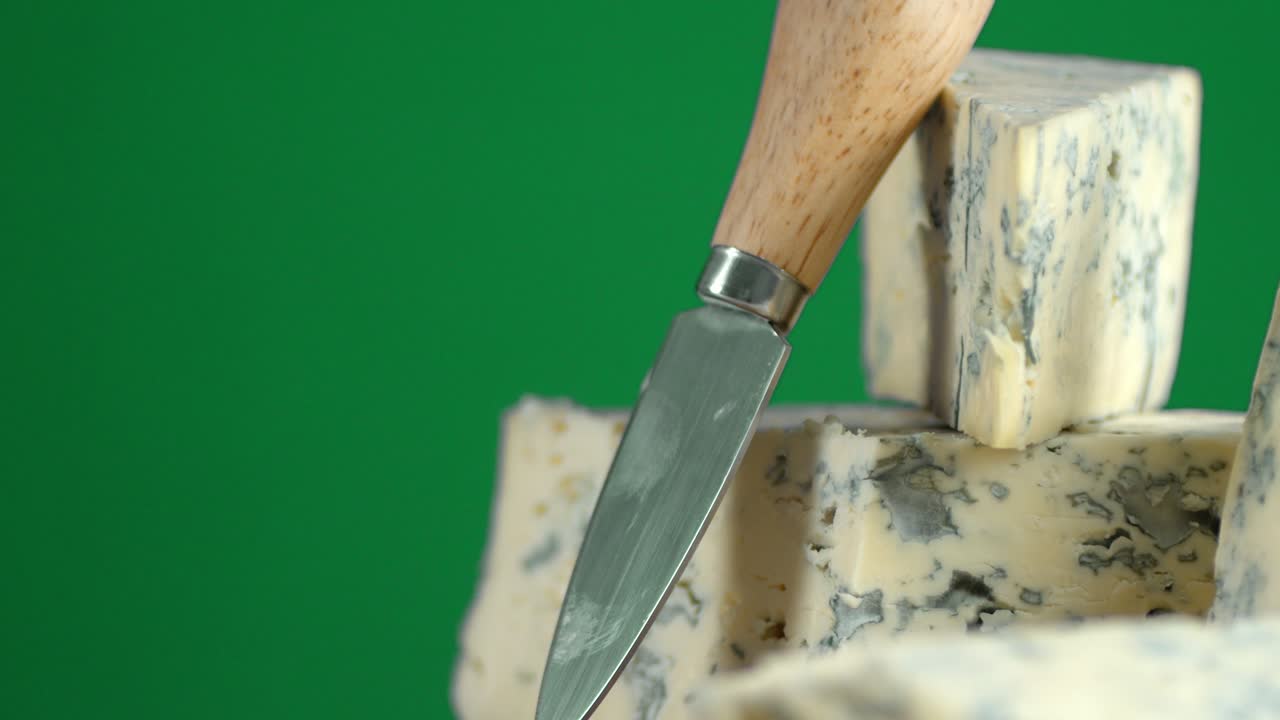 Brie cheese with a knife slowly rotates.