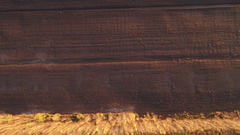 Aerial-view-of-the-large-wide-brown-peat-field-in-Kaunas-county,-Lithuania