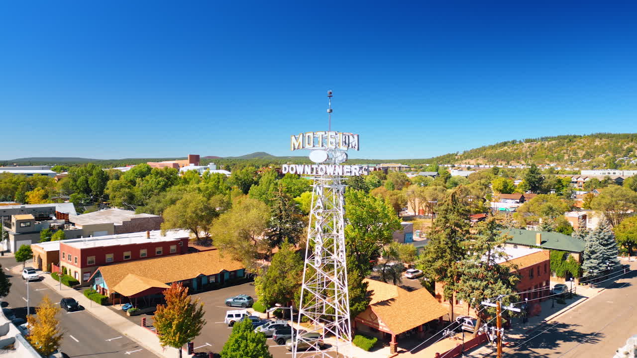 Flagstaff, USA, 24 August 2025: Tower with a signboard of a hotel. Low-rise buildings around. Aerial perspective on the scenery of Flagstaff, Arizona, USA