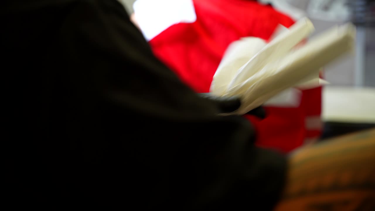 Tattoo artist prepares several sheets of paper to clean ink during session