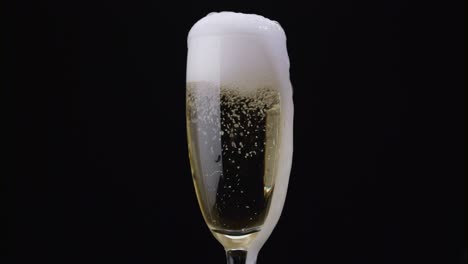 champagne bubbles rotating inside wine glass a closeup shot of a champagnefilled flute glass with bubbles rotating inside in slow motion against a dark background