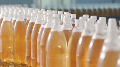 conveyor belt with bottles for juice or water at a modern beverage plant. modern production of sweet soda water