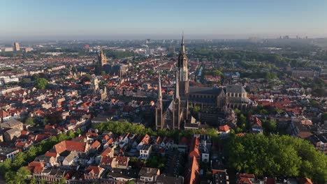 aerial zoom in of nieuwe kerk and catholic church spires in delft with panoramic cityscape in the background