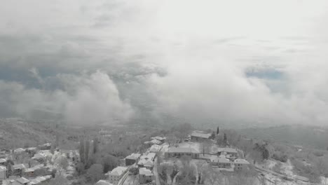 aerial footage from snowy mountain , traditional village in greece 1