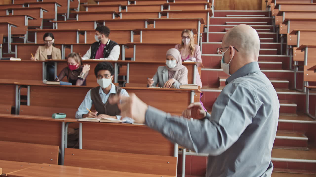 Male Professor and Group of Students in Face Masks Having Lesson