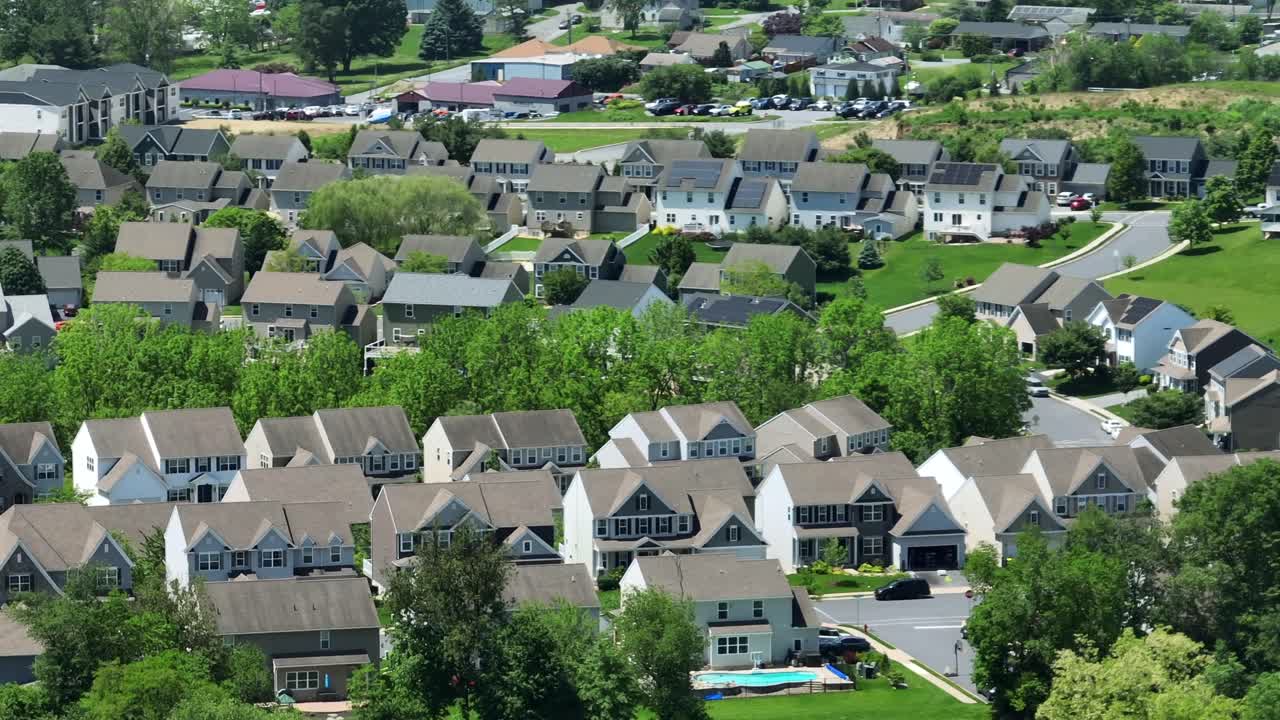 Exklusive and upper class two-story homes at sunny day in American suburb town. Aerial wide shot.
