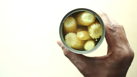 canned corn in a hand