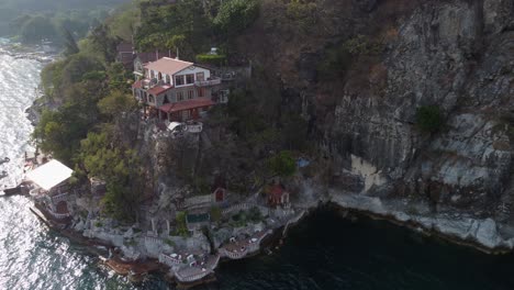 aerial orbits picturesque casa del mundo hotel on lakeshore rock cliff