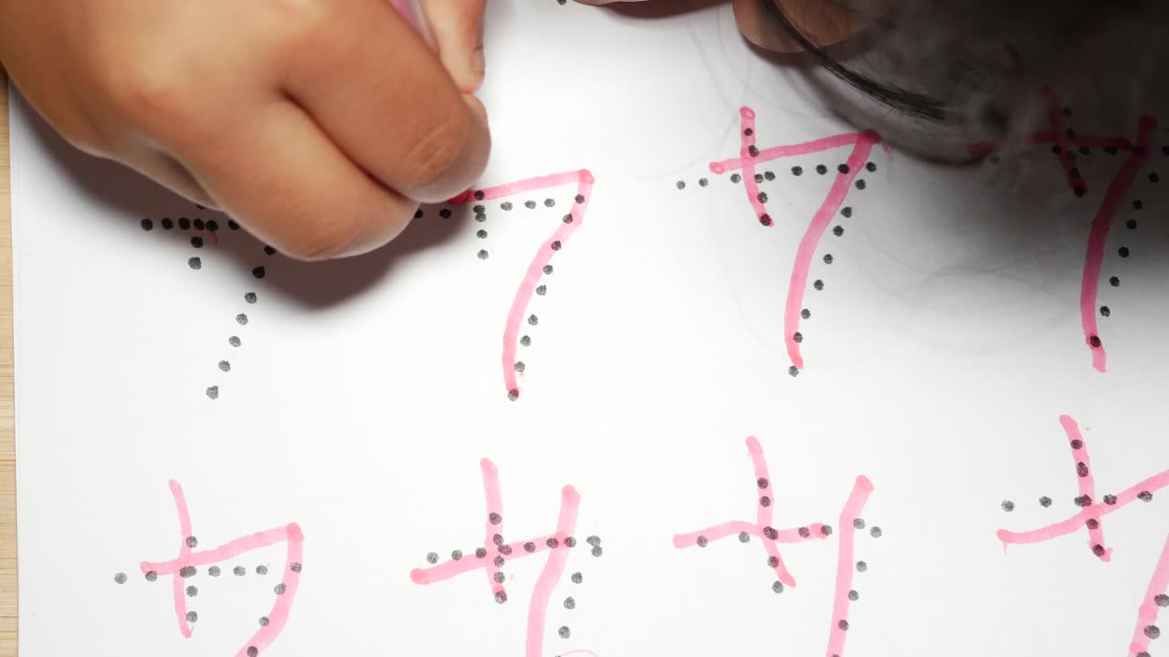 Child practicing writing numbers