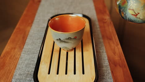 pouring tea into a traditional tea cup