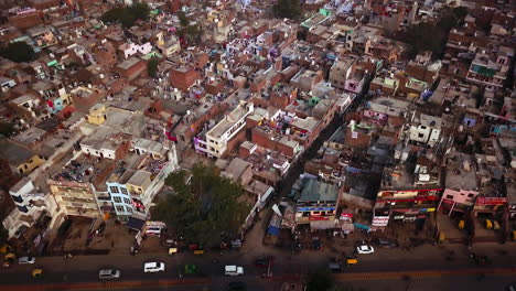 busy india street at arga near iconic taj mahal rural city scape smog pollution india view of busy streets with tuk tucks, bikes, cars and ricksaws aerial motion to the right