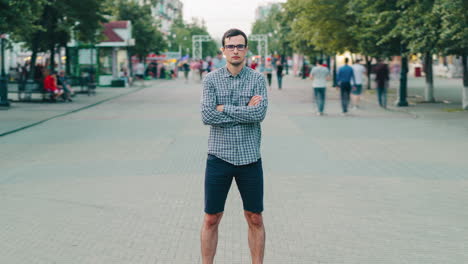 man standing on city street