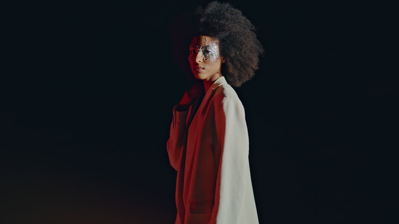 Stylish model turning light looking camera with art makeup. Festive clubber girl