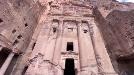 Petra-valley-in-Wadi-Musa,-Jordan-with-The-Treasury-in-the-middle-of-a-rocky-and-mountainous-landscape,-an-UNESCO-heritage-site,-ancient-Nabatean-Kingdom-4K-Establish-Shot