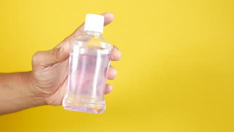 Hand-hold-a-mouthwash-liquid-container