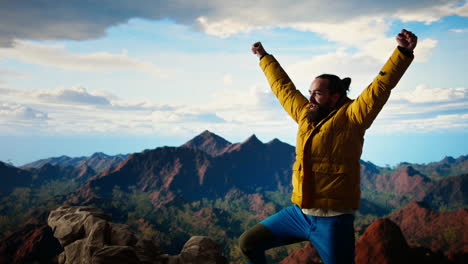 hiker dressed in warm outdoor gear celebrates reaching the top of a mountain