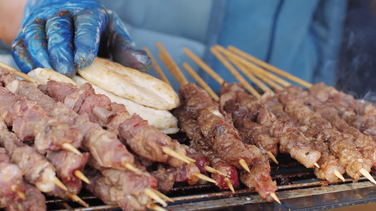 Pork meat skewer on fire, Mutton barbecue close-up. Fried meat for kebab. Cooking grilled meat beef chicken lamb BBQ . Kebab on grill. Chinese street local market with traditional food. Asian fast food.