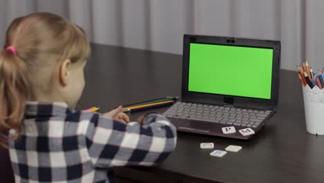 Children-distance-education-on-laptop-during-online-lesson-at-home.-Green-screen