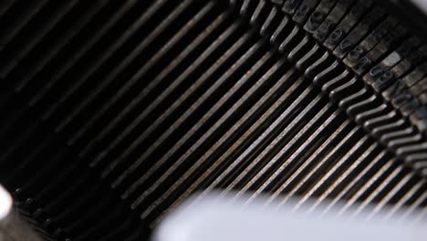 Macro-view-of-the-typebars-and-typebasket-inside-a-working-typewriter