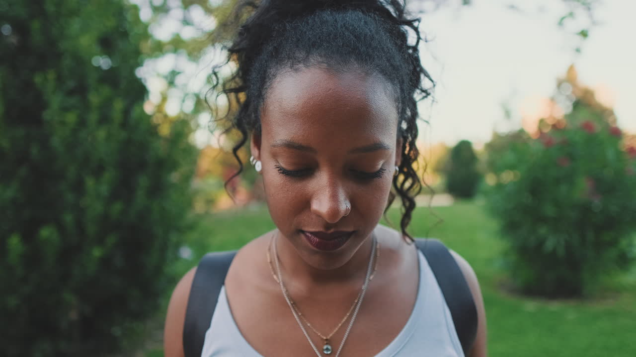 A beautiful African American woman in a park