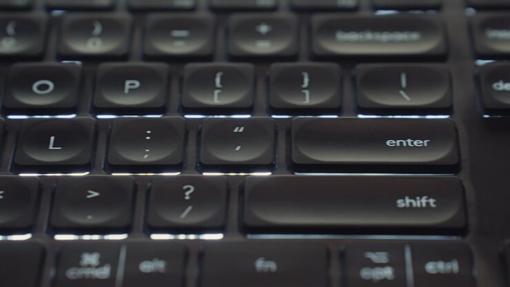 Close-up of an illuminated LED keyboard, glowing vibrantly