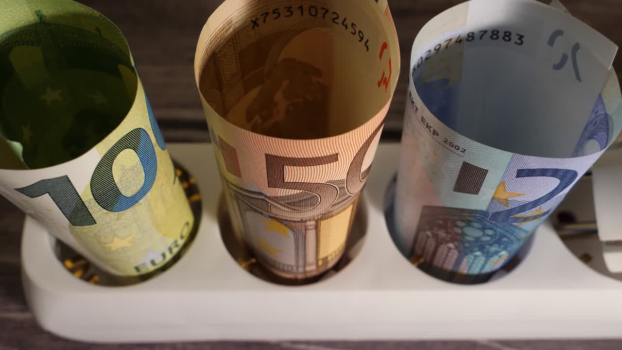 un primer plano de la moneda y un enchufe que muestra el concepto de alto precio de la energía.