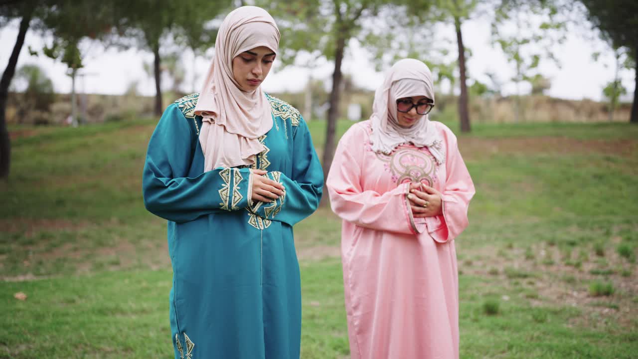 Two Muslim Women Praying Outdoors