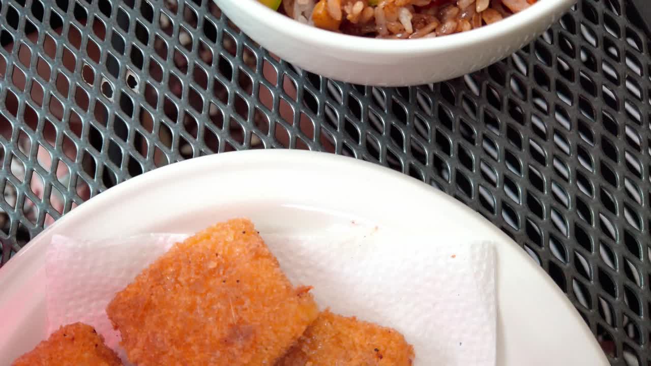 Close up shot of Cantonese rice and Kushikatsu on a table, handheld shot