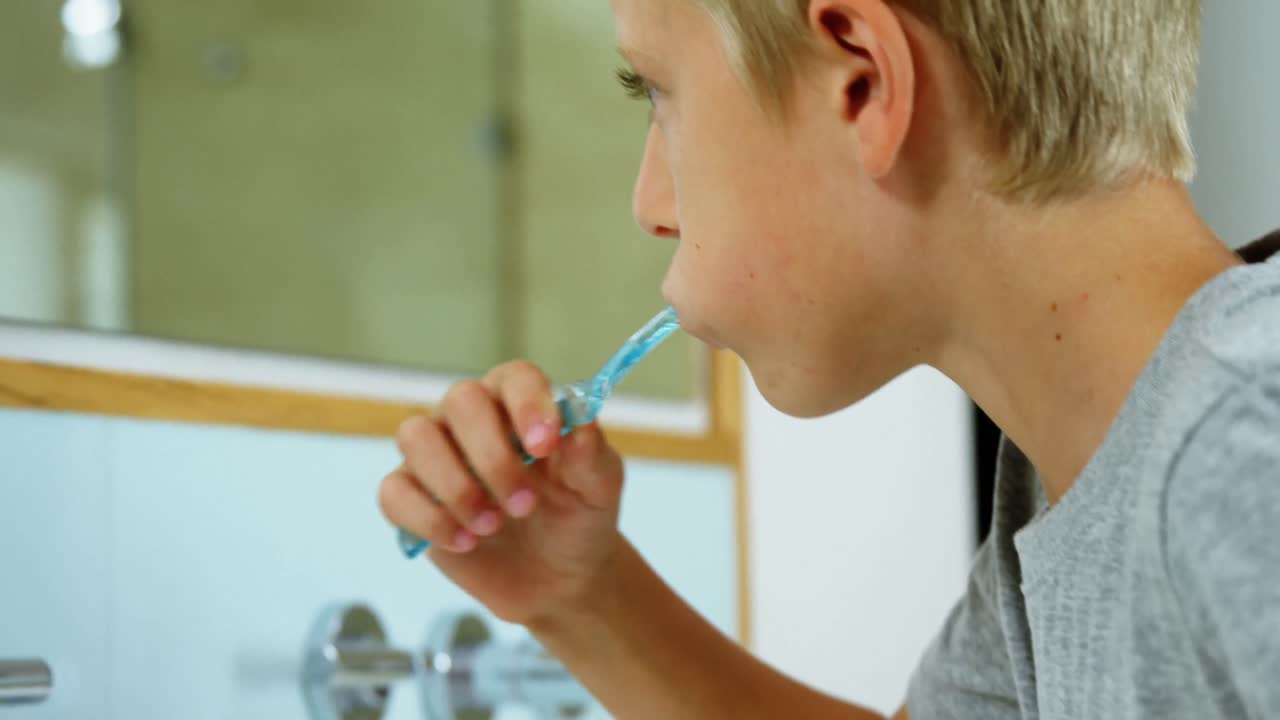 Boy brushing his teeth in bathroom