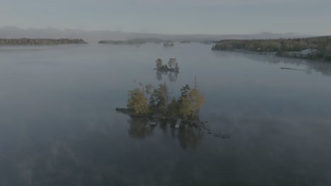 aerial over islands surrounded by fog on moosehead lake