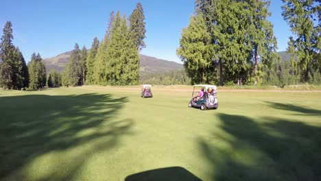 People-riding-golf-cart-in-golf-course-4k