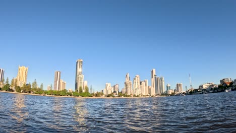 city skyline viewed from water, clear blue sky